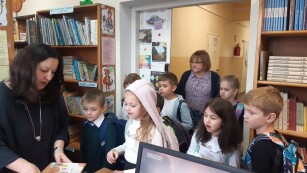 dzieci klas pierwszych odwiedzają bibliotekę szkolną