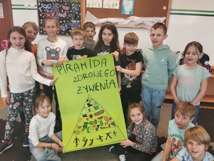 Uczniowie przebywający na świetlicy szkolnej przygotowali plakat dotyczący piramidy zdrowego żywienia